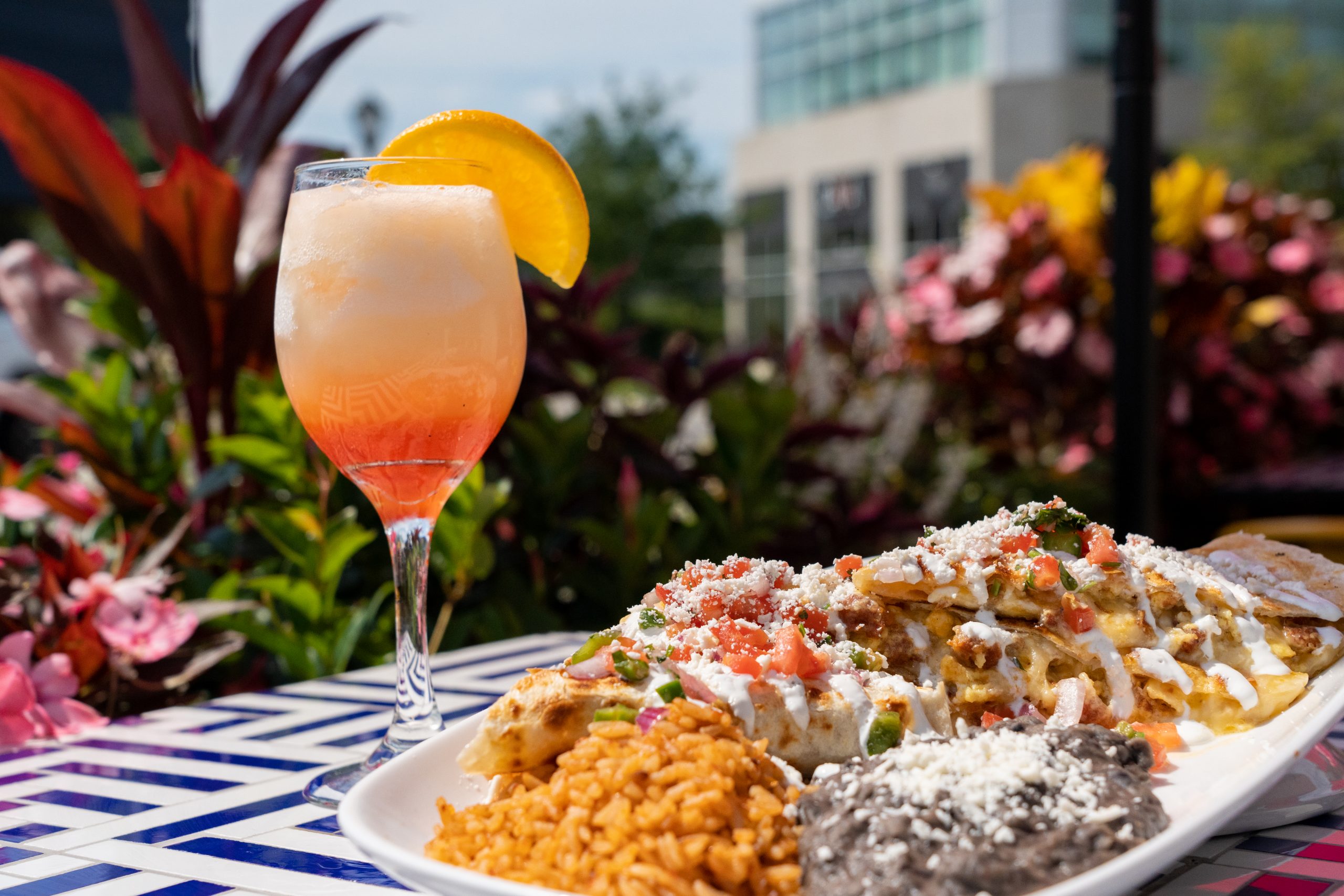 A fiesta platter and bright cocktail on a table at Rosa Mexicano