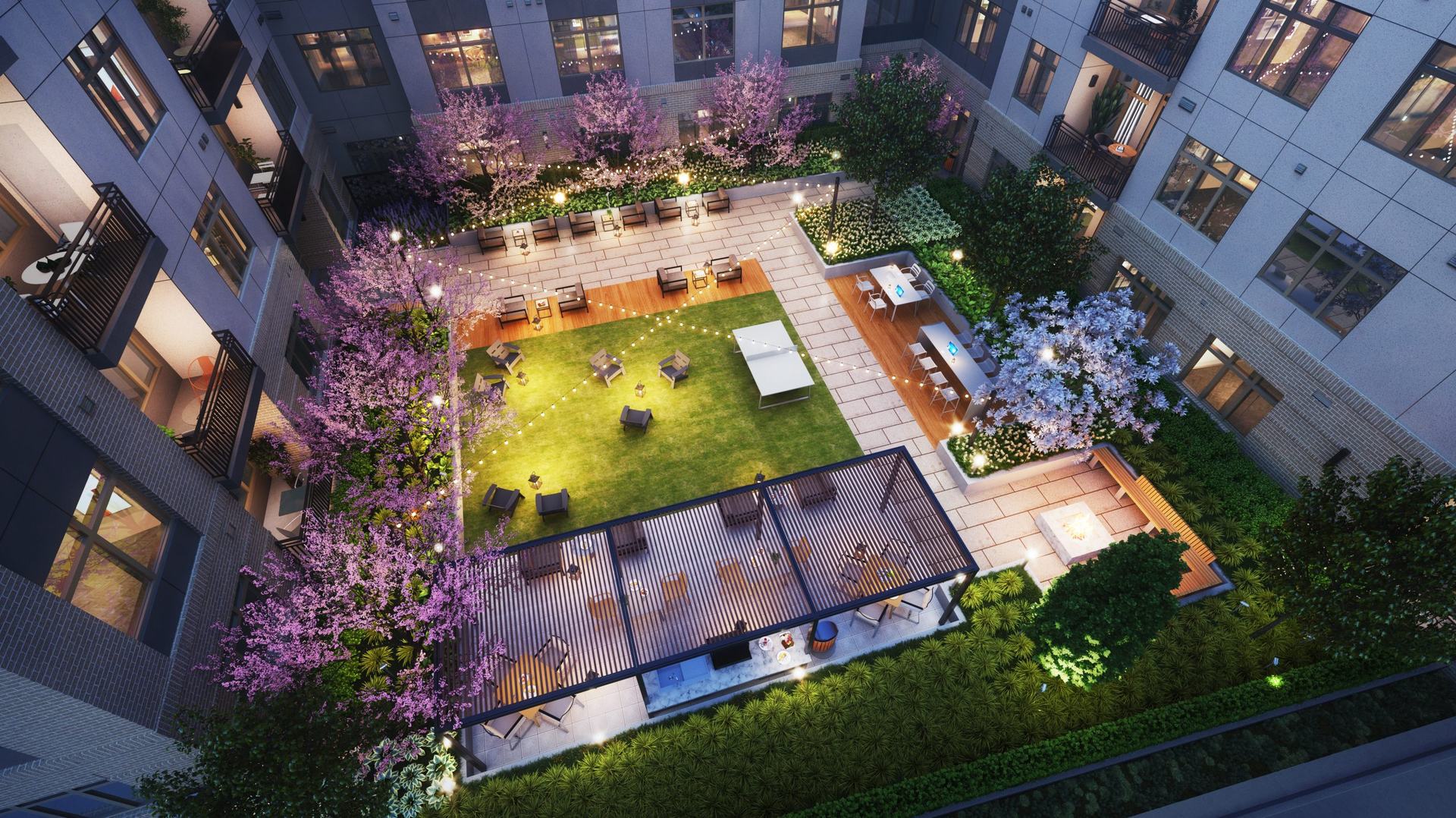 The active courtyard with pool, outdoor grilling station and lounge areas