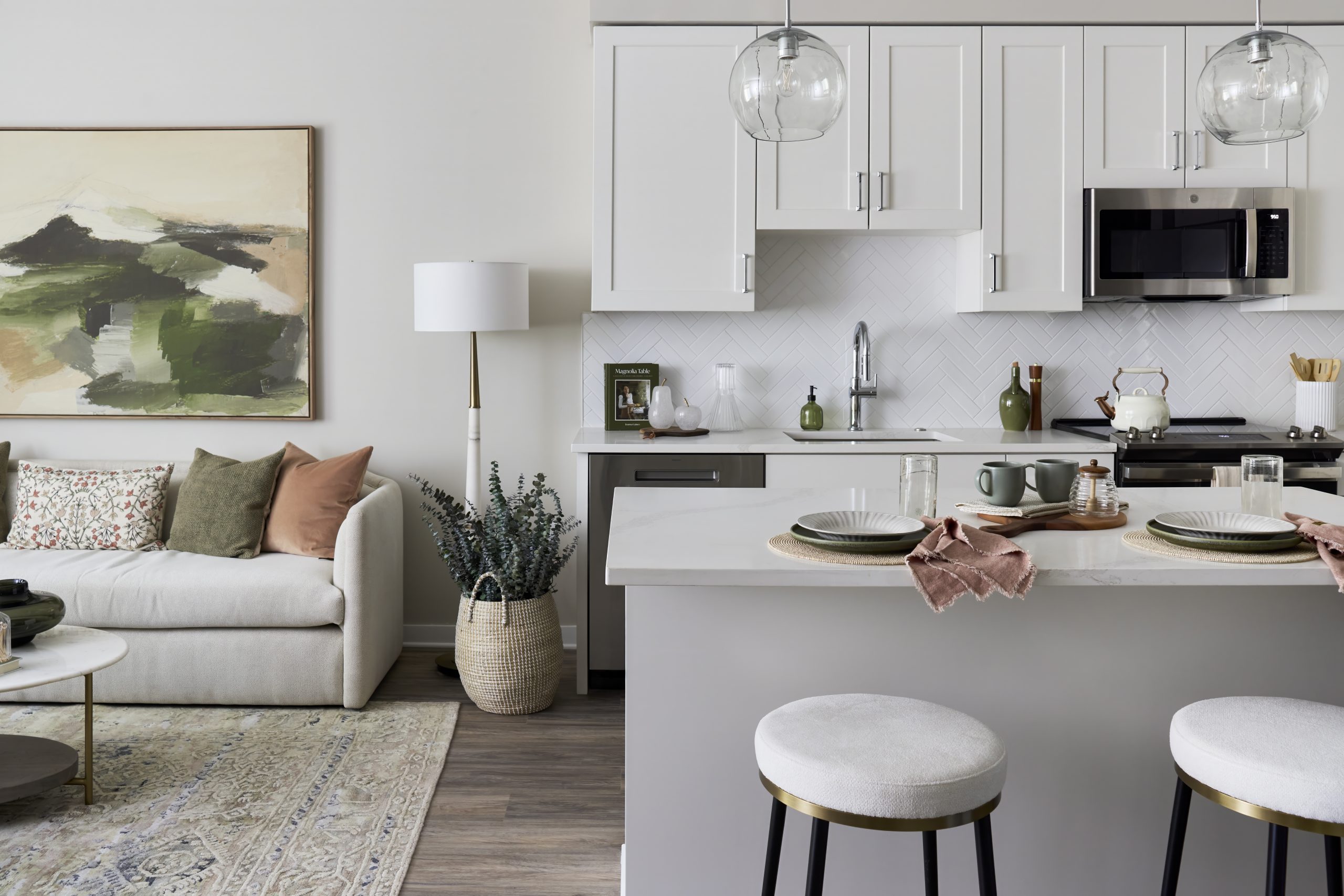 Apartment home interior with kitchen with stainless steel appliances and island